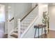 Traditional staircase featuring dark wood treads, white risers, and craftsman style railing at 5497 Alpine Dr, Summerville, SC 29483