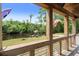 Scenic view from the porch showcasing the backyard, river, dock, and mature trees at 5653 Wire Rd, Branchville, SC 29432