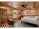 Cozy bedroom featuring a bed, wood-paneled walls and ceiling, a window, and modern ceiling fan at 5653 Wire Rd, Branchville, SC 29432