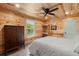 Bedroom featuring wood paneling, a large window, ceiling fan, and built in desk at 5653 Wire Rd, Branchville, SC 29432