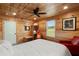 Comfortable bedroom with wood-paneled walls, ceiling fan, decor, and natural light at 5653 Wire Rd, Branchville, SC 29432