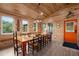 Inviting dining room features wood paneling, a large table with seating for twelve, and natural light at 5653 Wire Rd, Branchville, SC 29432