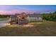 Charming home featuring a screened-in porch and views of the landscaped yard at 5653 Wire Rd, Branchville, SC 29432