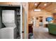 Hallway and laundry area with wood paneling leads to an open bedroom at 5653 Wire Rd, Branchville, SC 29432