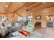 Open-concept living room with wood paneling, comfortable seating, and seamless flow to the kitchen at 5653 Wire Rd, Branchville, SC 29432