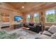 Cozy living room with wood paneling, comfortable couches, and a large television at 5653 Wire Rd, Branchville, SC 29432