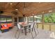 Spacious covered patio with ceiling fan, dining table with chairs and outdoor lounge seating at 5653 Wire Rd, Branchville, SC 29432