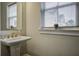 Comfortable bathroom featuring pedestal sink, mirror and bright window at 5911 Steward St # 24, Hanahan, SC 29410