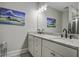 Modern bathroom featuring double sinks, granite countertop and attractive sailboat art at 5911 Steward St # 24, Hanahan, SC 29410