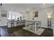 Stylish dining area with a hardwood floor and view to the kitchen with a large island at 5911 Steward St # 24, Hanahan, SC 29410