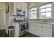 Bright kitchen featuring white cabinets, stainless steel appliances, and granite countertops at 5911 Steward St # 24, Hanahan, SC 29410