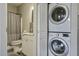 Stacked washer and dryer adjacent to well-lit bathroom at 5911 Steward St # 24, Hanahan, SC 29410
