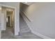 Carpeted staircase with a white railing ascends to the upper level, with a hallway visible through an open doorway at 5911 Steward St # 24, Hanahan, SC 29410