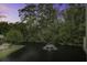 Sunset view of a pond and fountain surrounded by trees, seen from the balcony at 5911 Steward St # 24, Hanahan, SC 29410