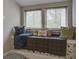 Charming window seat nestled between two windows with decorative pillows and cushion for a cozy reading nook at 5911 Steward St # 24, Hanahan, SC 29410