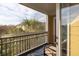 View from the balcony featuring palm trees and a glimpse of the surrounding buildings at 600 Bucksley Ln # 305, Charleston, SC 29492