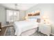 Bright bedroom with a large bed, beach-themed artwork, and natural light from the window at 600 Bucksley Ln # 305, Charleston, SC 29492