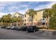 Apartment building exterior with palm trees and parking lot under a blue sky at 600 Bucksley Ln # 305, Charleston, SC 29492