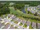 Community aerial view showcases the neighborhood's layout, lush golf course, and tranquil pond at 6176 Wilkes Pond Dr, Hollywood, SC 29449