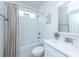 Bright bathroom featuring a tub with white subway tile, white vanity, and neutral-toned shower curtain at 6176 Wilkes Pond Dr, Hollywood, SC 29449