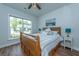 Inviting bedroom with a wood frame bed, and a window offering a view of the outdoors, complemented by neutral tones at 6176 Wilkes Pond Dr, Hollywood, SC 29449