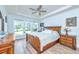 Cozy bedroom with a classic wooden bed frame, complemented by natural light streaming through the window at 6176 Wilkes Pond Dr, Hollywood, SC 29449