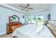 Bright bedroom featuring a classic wood bed frame and a view of the outdoors through a set of windows at 6176 Wilkes Pond Dr, Hollywood, SC 29449