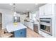 Bright kitchen with stainless steel appliances, white cabinets, and an island with seating at 6176 Wilkes Pond Dr, Hollywood, SC 29449