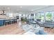 Open-concept living space with modern kitchen, dining area, and spacious seating area with natural light and stylish decor at 6176 Wilkes Pond Dr, Hollywood, SC 29449