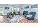 Bright living room with large windows, comfortable seating, and decorative rug, perfect for relaxing and entertaining at 6176 Wilkes Pond Dr, Hollywood, SC 29449