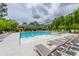 Community pool with splash pad, surrounded by lush landscaping and ample seating, offering a serene retreat for residents at 6176 Wilkes Pond Dr, Hollywood, SC 29449