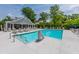 Community pool featuring clear blue water, a splash pad, plenty of lounge seating, and a convenient lift for accessibility at 6176 Wilkes Pond Dr, Hollywood, SC 29449