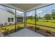 Covered and screened porch with view of the yard, plants, and landscaping at 6176 Wilkes Pond Dr, Hollywood, SC 29449