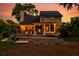 The spacious backyard deck is illuminated by string lights at dusk, creating an inviting outdoor space at 679 Clearview Dr, Charleston, SC 29412