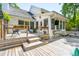 Enjoy outdoor living on this expansive wooden deck, perfect for entertaining or relaxing with string lights above at 679 Clearview Dr, Charleston, SC 29412