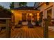 A cozy backyard deck featuring comfortable seating and warm string lights creates a relaxing evening ambiance at 679 Clearview Dr, Charleston, SC 29412