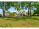 Spacious backyard featuring a well-maintained lawn, mature trees, and an outdoor deck area at 679 Clearview Dr, Charleston, SC 29412