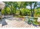 Expansive backyard with a large deck, bench seating, open green space, mature trees, and play area at 679 Clearview Dr, Charleston, SC 29412