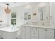 Bright bathroom with dual sinks, a soaking tub, and natural lighting at 679 Clearview Dr, Charleston, SC 29412