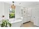 Well-lit bathroom featuring a soaking tub, double sink vanity, and leafy green view from the window at 679 Clearview Dr, Charleston, SC 29412