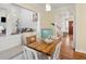 Bright dining area with a wooden table, window seat, and an open view into the living room at 679 Clearview Dr, Charleston, SC 29412