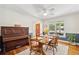 Dining room showcasing a wooden table set for four, with a piano and a view through the window at 679 Clearview Dr, Charleston, SC 29412