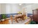 Cozy dining room with a wooden table, white and blue walls, ceiling fan, and hardwood floors at 679 Clearview Dr, Charleston, SC 29412