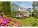 Well-maintained two story home featuring a covered porch, manicured lawn, and colorful azalea bushes at 679 Clearview Dr, Charleston, SC 29412