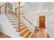 The foyer features a wooden staircase, hardwood floors, and a striking front door at 679 Clearview Dr, Charleston, SC 29412