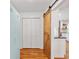 Hallway features hardwood floors and decorative sliding barn door at 679 Clearview Dr, Charleston, SC 29412