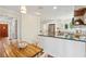 This bright kitchen features white cabinets, stainless steel appliances, granite countertops, and a wooden table at 679 Clearview Dr, Charleston, SC 29412