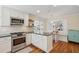 Charming kitchen with stainless steel appliances, white cabinets, granite countertops, and an adjacent dining area at 679 Clearview Dr, Charleston, SC 29412