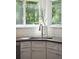 The kitchen sink is located next to a window and features white cabinets, granite countertops, and tile backsplash at 679 Clearview Dr, Charleston, SC 29412