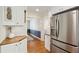 The kitchen features stainless steel appliances, wooden countertops, white cabinets, and hardwood floors at 679 Clearview Dr, Charleston, SC 29412